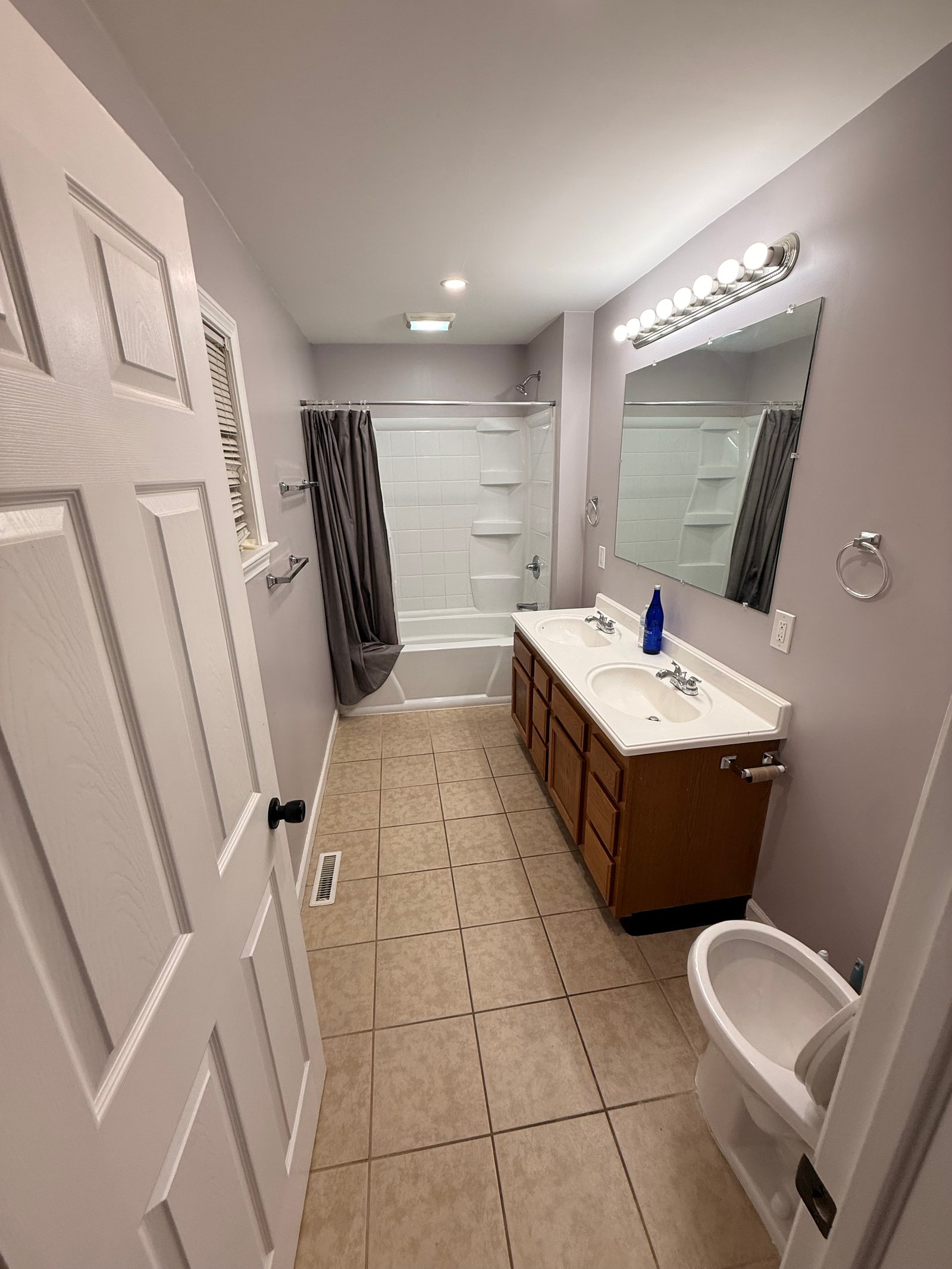 Bright cleaned bathroom with double vanity and shower