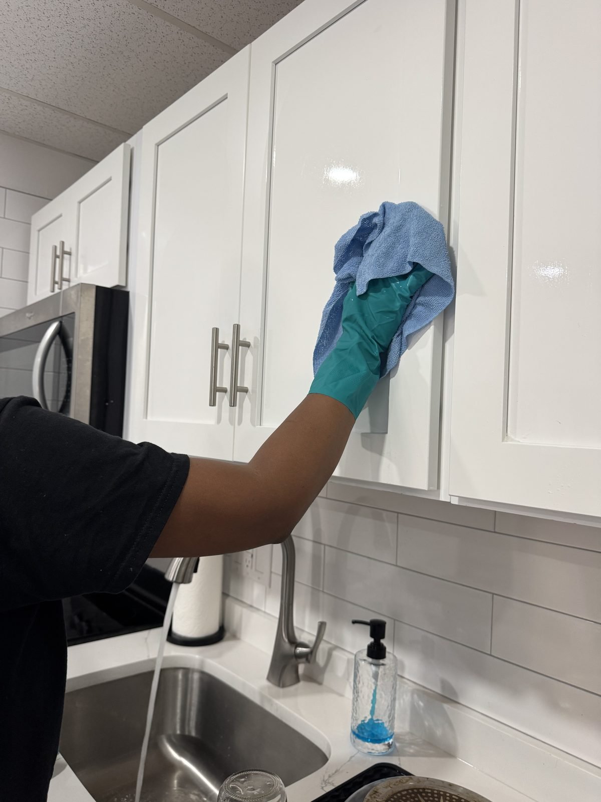 Wiping down kitchen cabinet doors